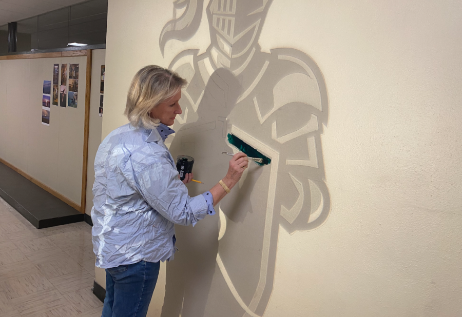 Art teacher Dawn Schmidt begins painting a knight on the first-floor hallway of Rice Memorial High School in January 2023. (Photo/Hannah Cunningham)