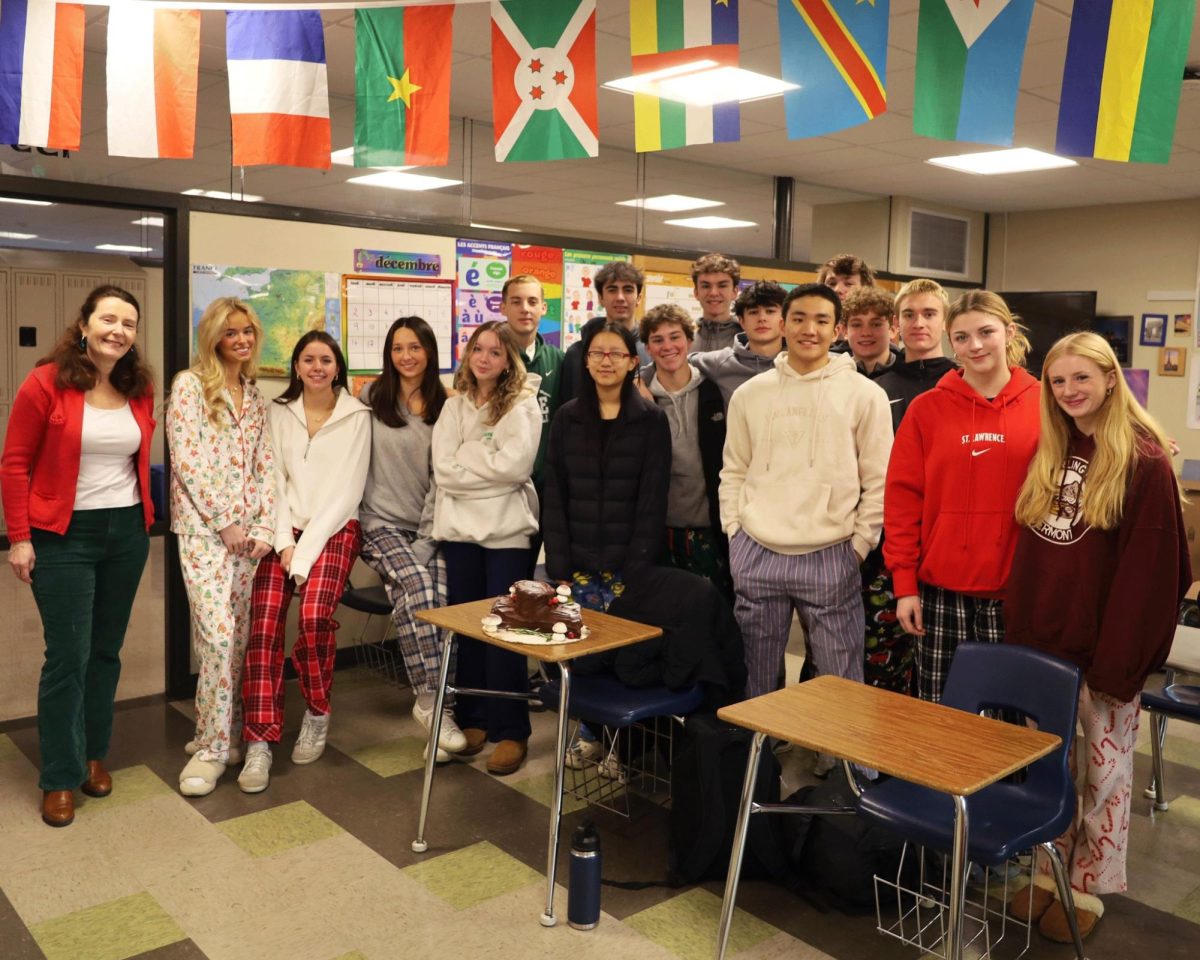 Madame Giron with her French students celebrating a Joyeux Noël with buche de noël (Christmas log cakes). (Photo/Megan Shrestha) 