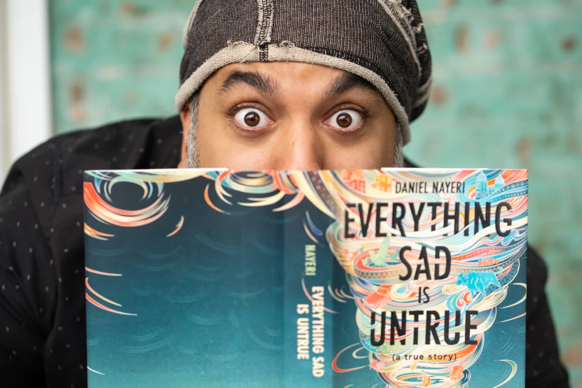 Daniel Nayeri with his book Everything Sad Is Untrue.