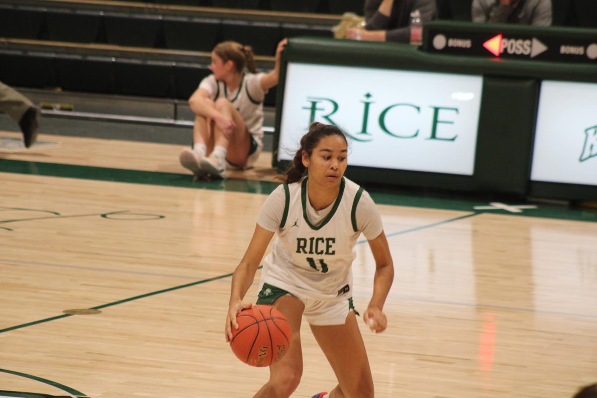 Junior Alexis Menard-O'Neil dribbles the ball at the top of the key against St. Johnsbury.