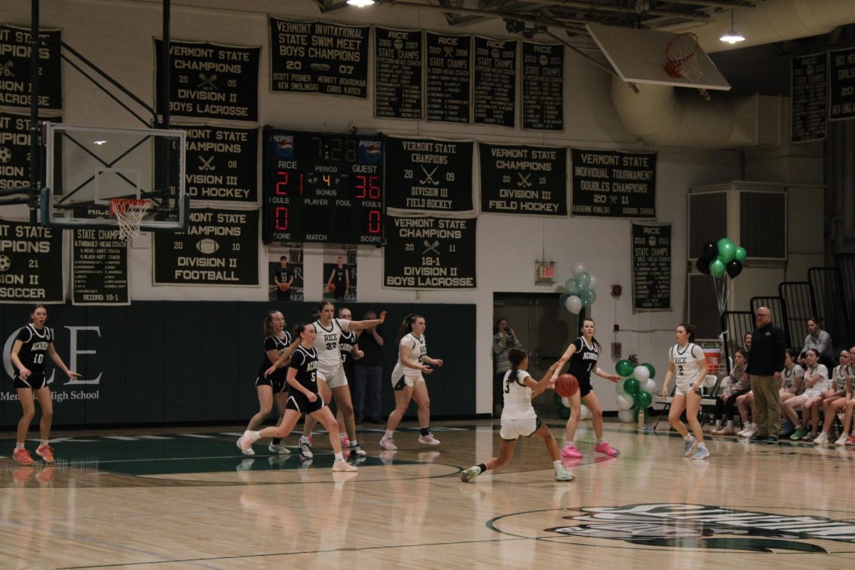 Senior Reese Billings dribbles at the three point line against St. Johnsbury Academy.