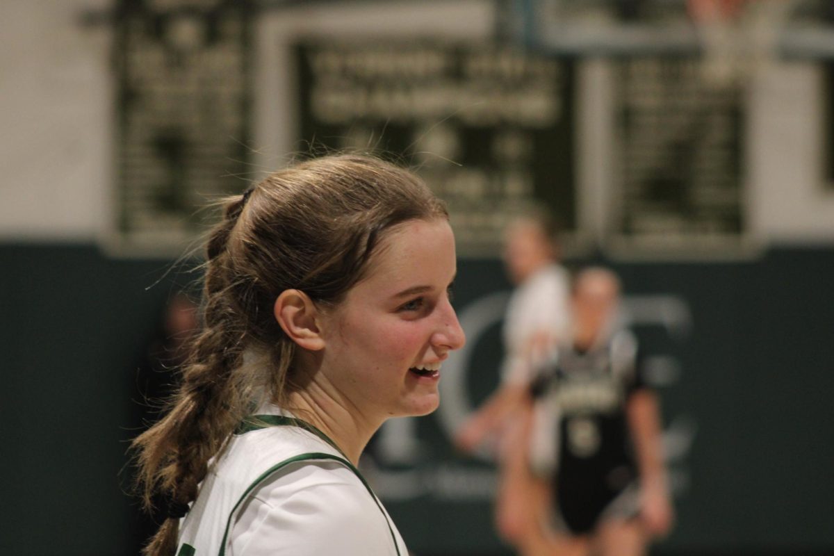 Sophomore Sara Guidice smiles before taking the ball out at Rice's Senior Game.