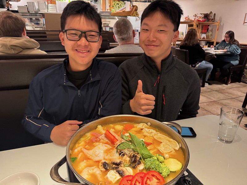 Rice International Students Quan "Tiger" Le and Junhang "Joe" Huang eating at a restaurant for an excursion provided by Rice.