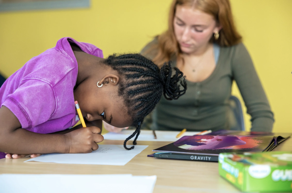 Senior Mary Moyer and her book buddy at King Street Center. (Photo/King Street Center website)